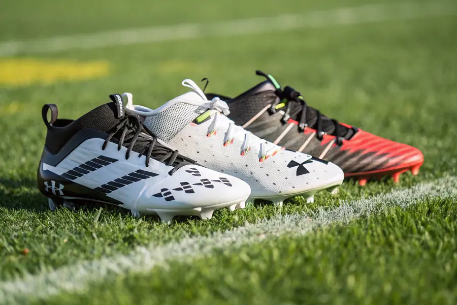 A set of cleats showcasing differences between soccer and American football positions, highlighting features like stud types, upper materials, and cleat heights for various roles.