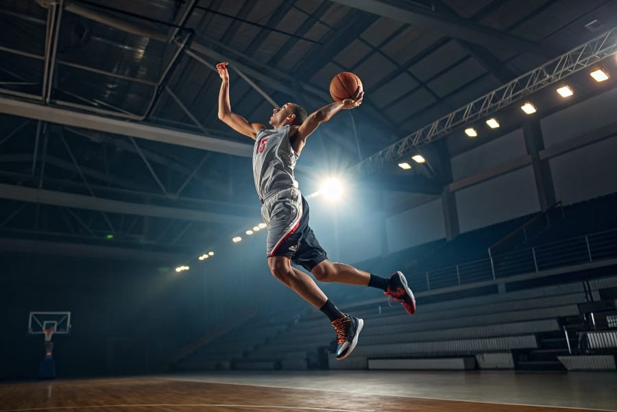 Photo-realistic image of an athlete performing a sports movement, illustrating subtle misalignments in their body starting from the foot, representing the effect of flat feet on biomechanics